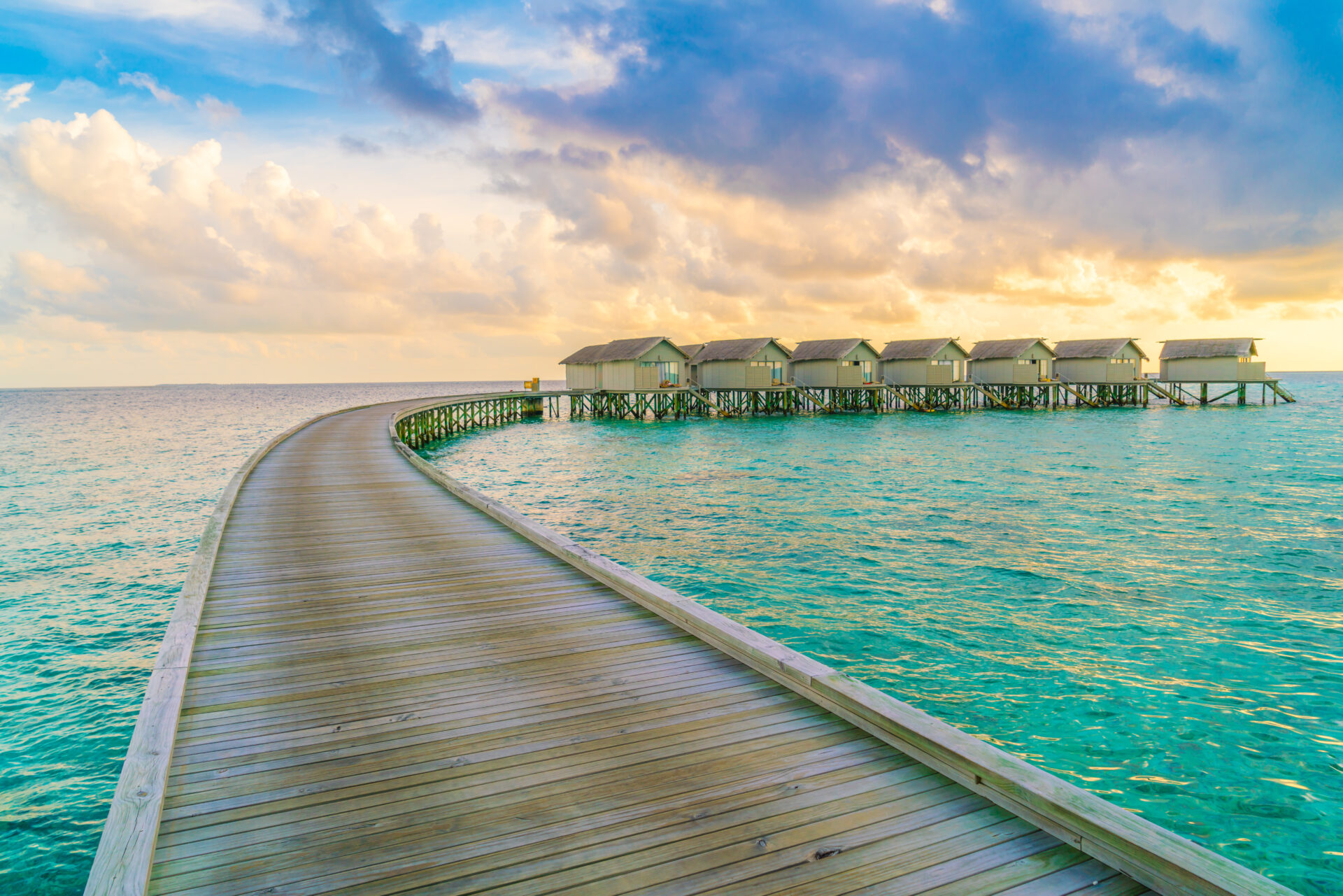Beautiful water villas in tropical Maldives island at the sunset time